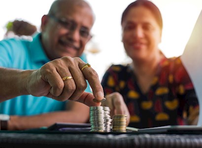 older couple stacking coins