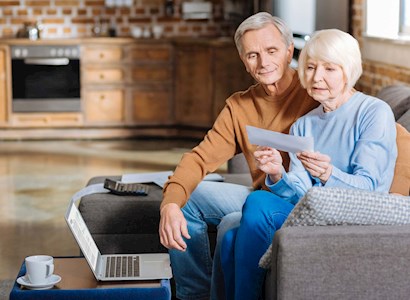 Older couple reading report on couch