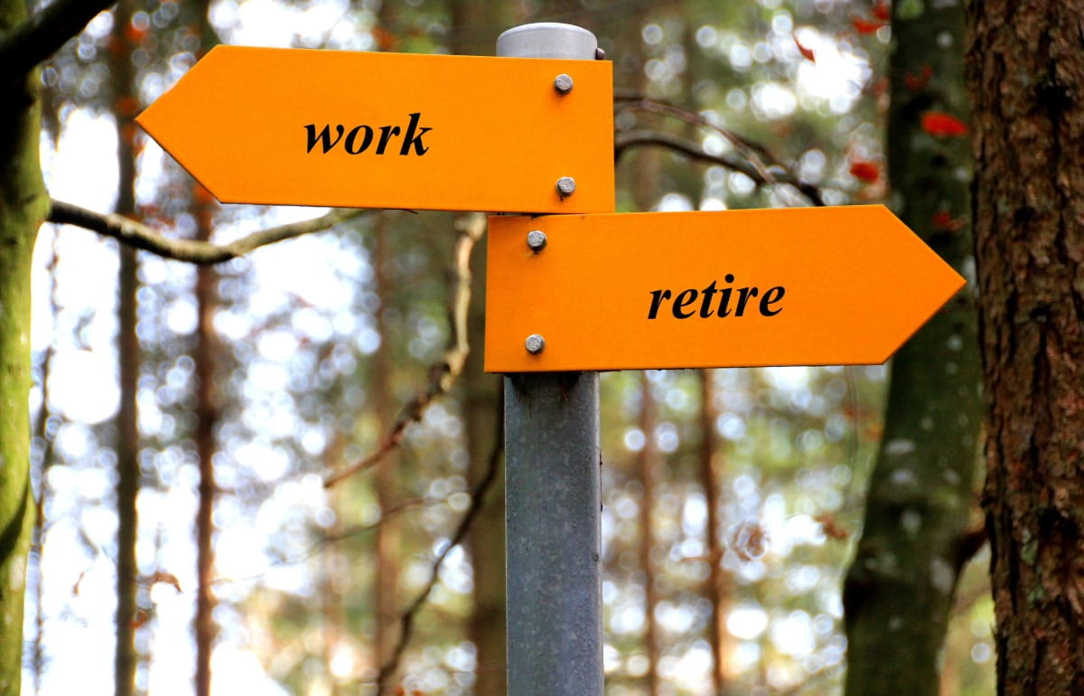 Road sign pointing in opposite directions for work and retire
