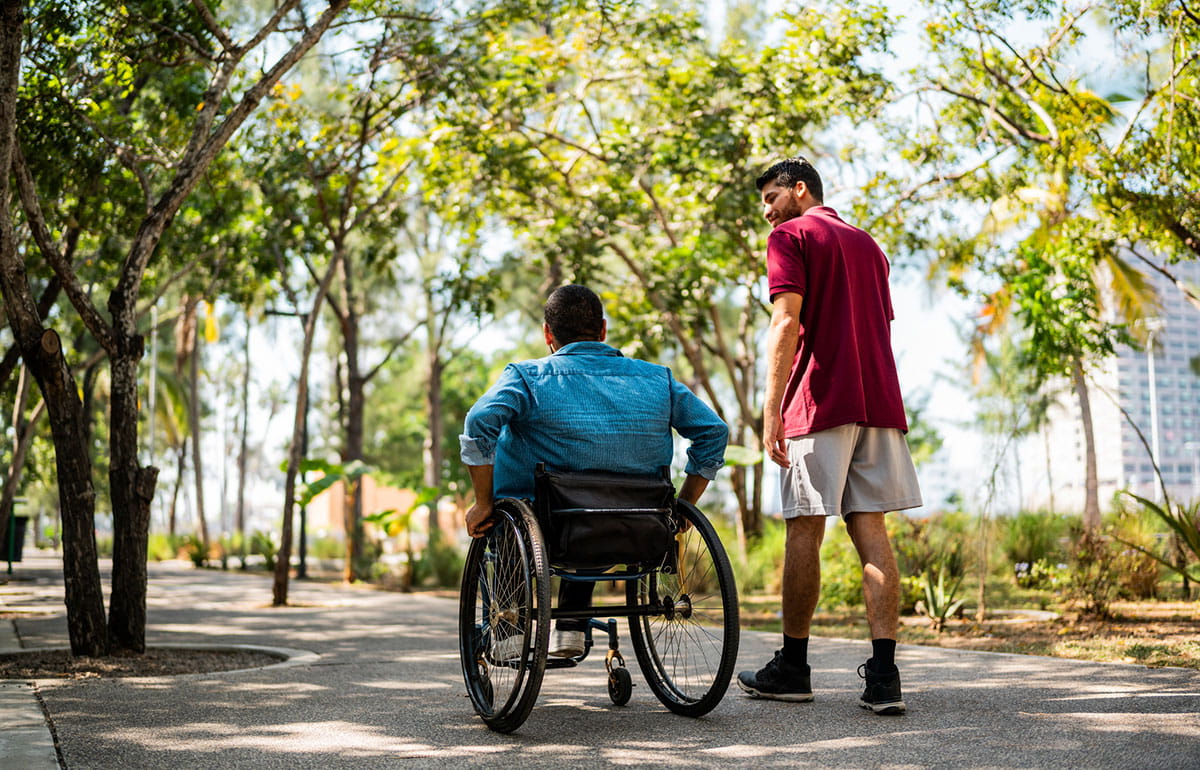 Adult with a disability and family member reviewing financial planning documents.