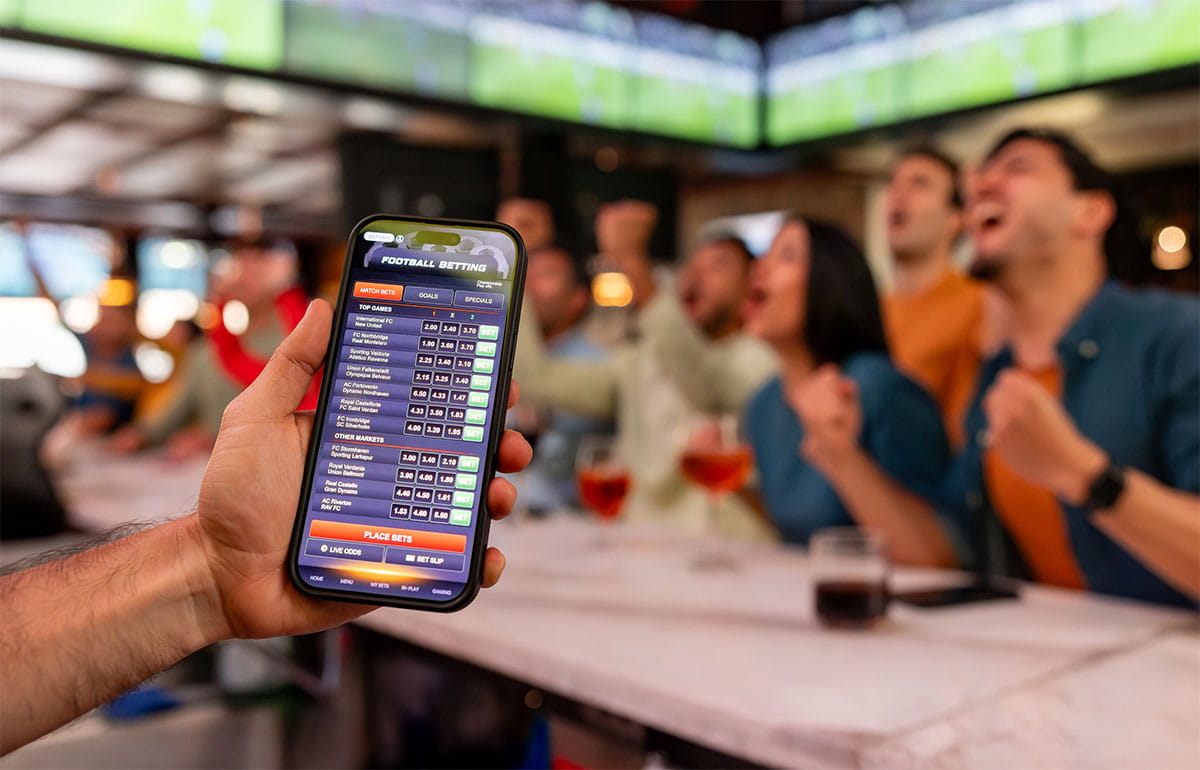 Person reviewing betting activity and household finances on a smartphone.