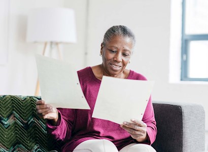 older woman reading financial documents