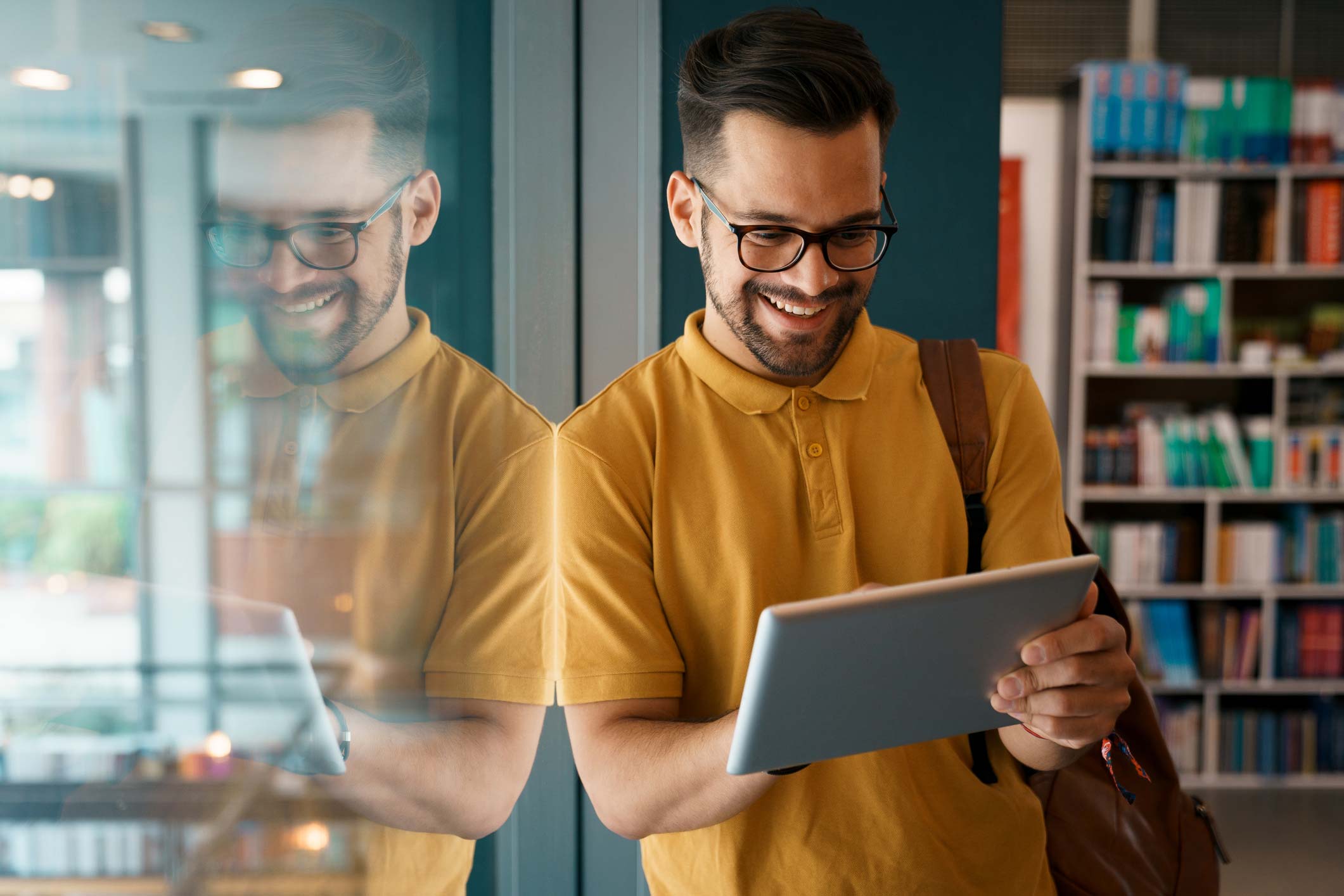 Man smiling using his tablet.