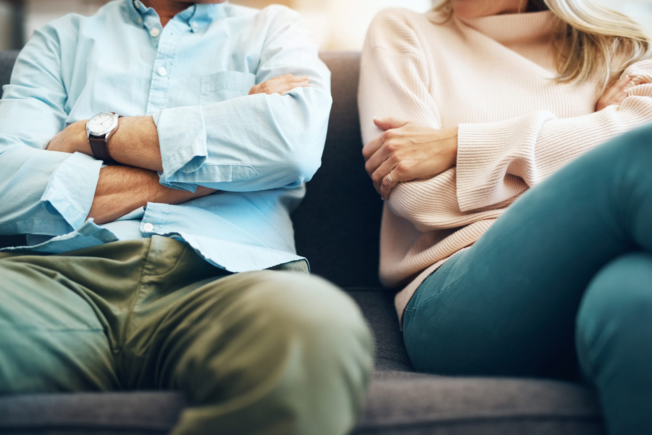 couple sitting next to each other with arms crossed