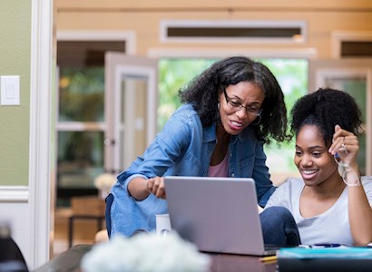 Two women looking at laptop
