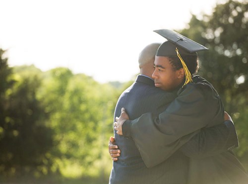 Graduate hugging father