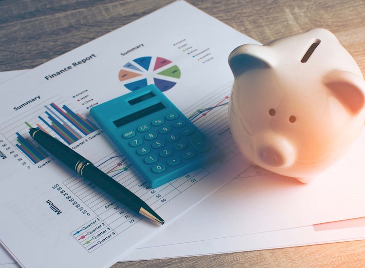 Piggybank on top of finance report