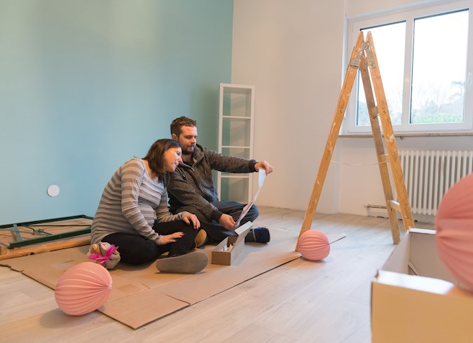 A couple preparing a room for a baby