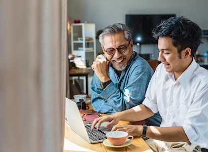 Father and son working on laptop