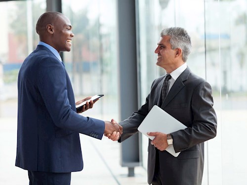 financial planner shaking hands with a client