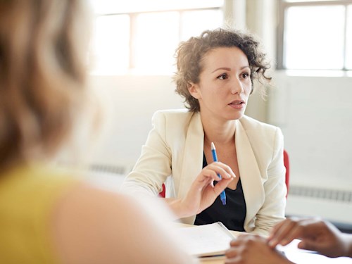 Female financial planner advising clients