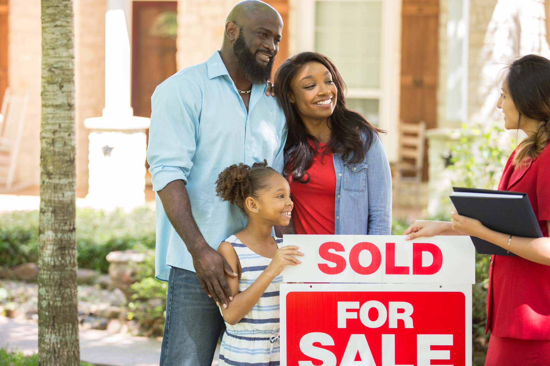 Family smiling at financial planner