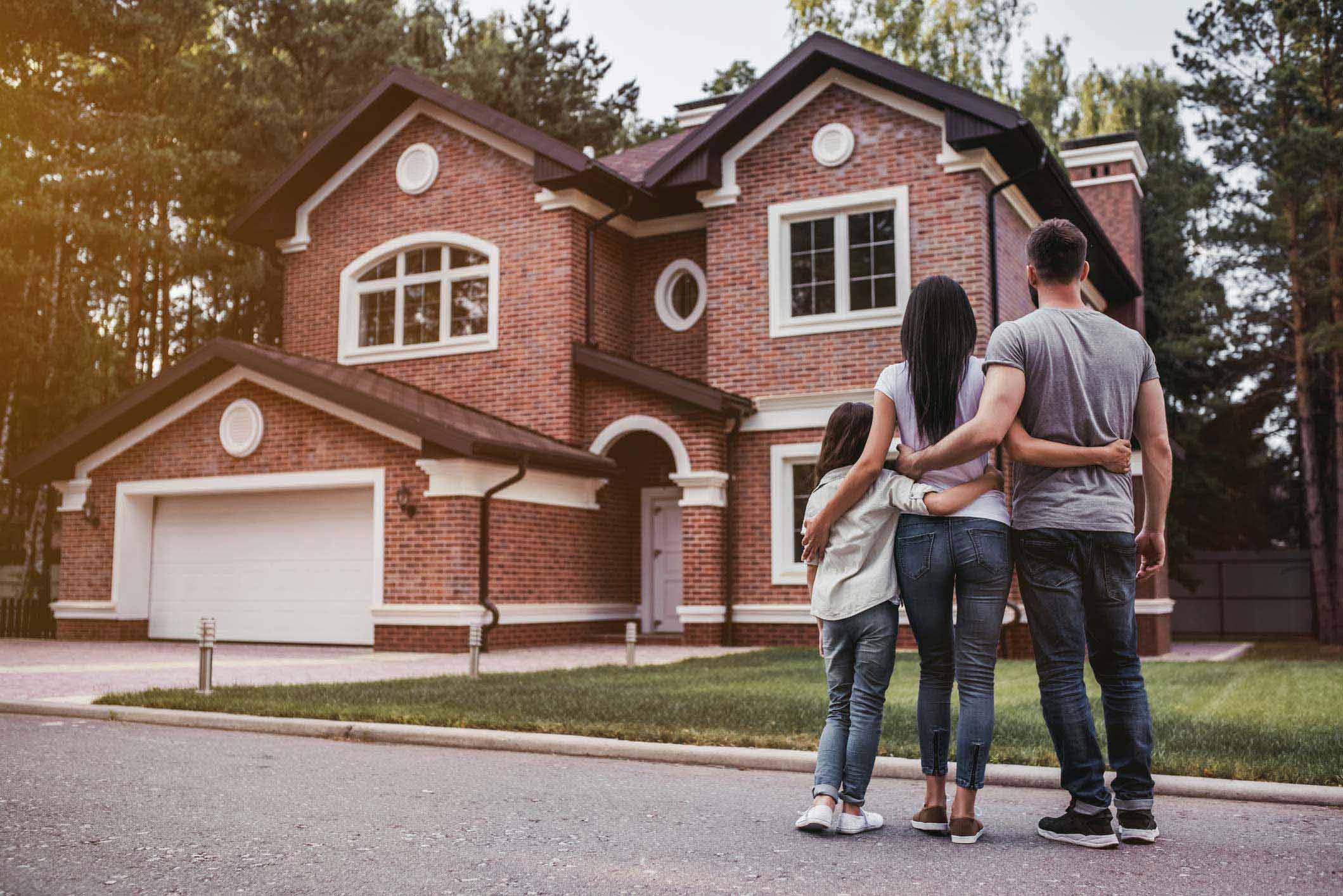 Family admiring house
