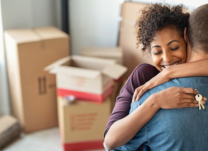 Woman hugging man and holding home key