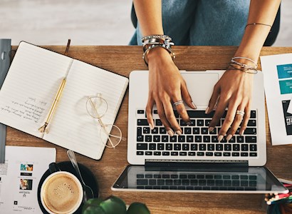 A person types on a laptop.