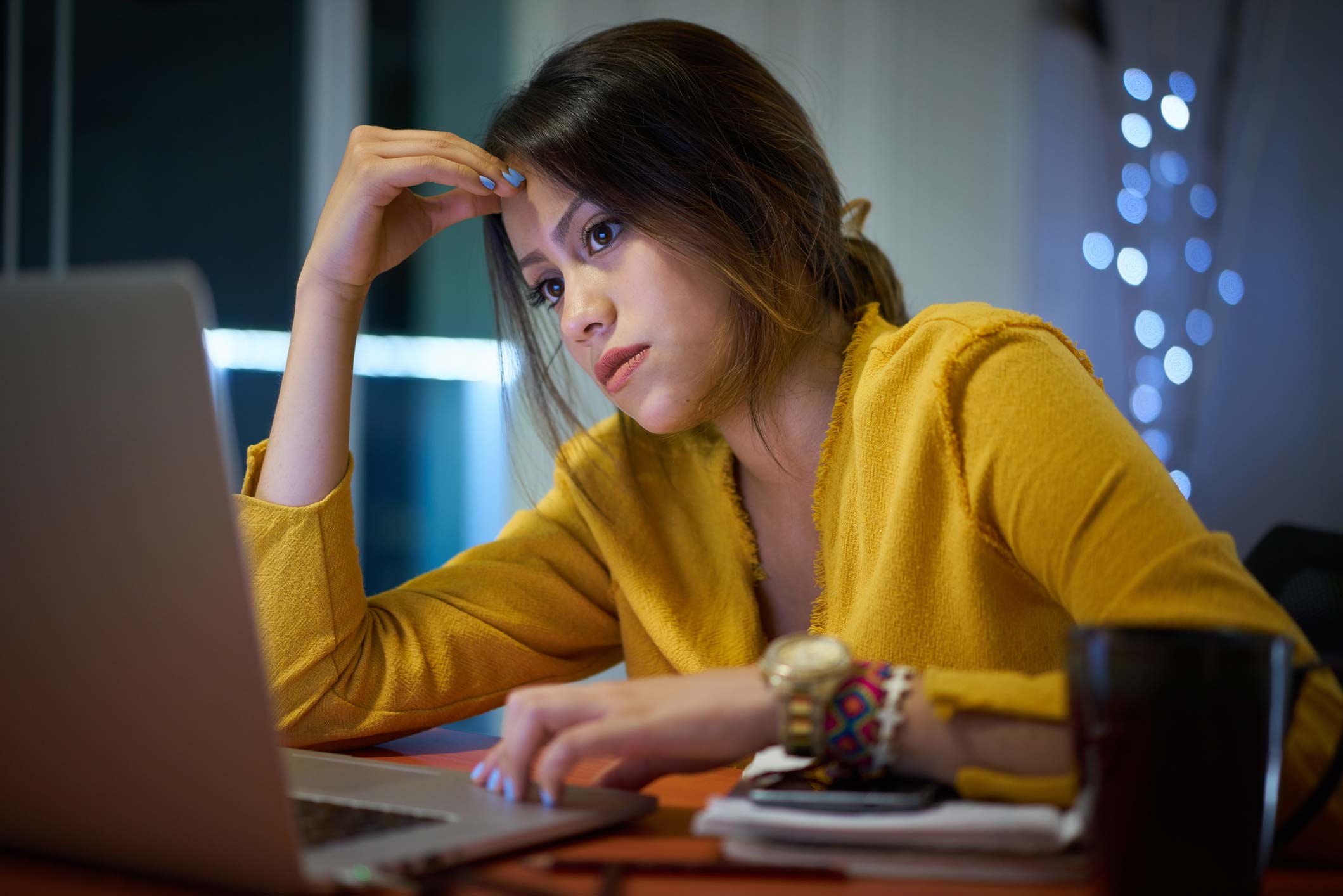 Young woman intensely looking at computer screen 