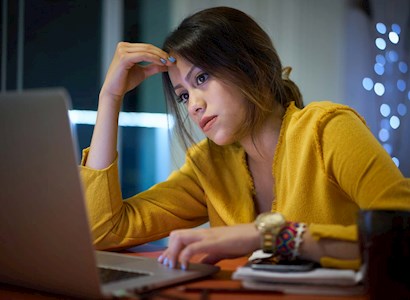 Young woman intensely looking at computer screen 