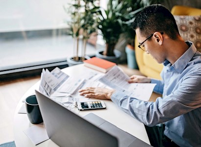 Young asian man reviewing reports